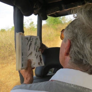 Guest is refering a birding guide during a safari in Sri Lanka 